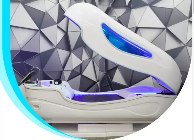 A white and blue massage chair with a blue light on it.