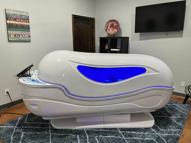 A white and blue massage chair in a room.